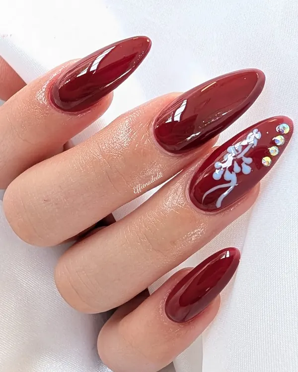 Burgundy almond with a floral accent nail art by Divine Grace Nails Studio, Edmonton