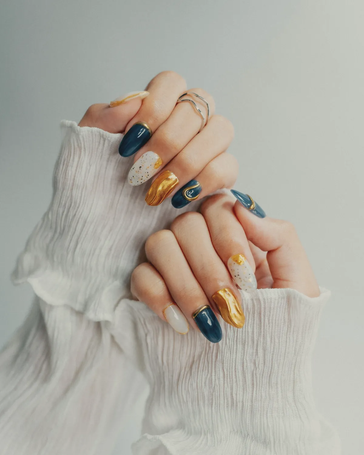 Navy, gold and white nail art on long nails