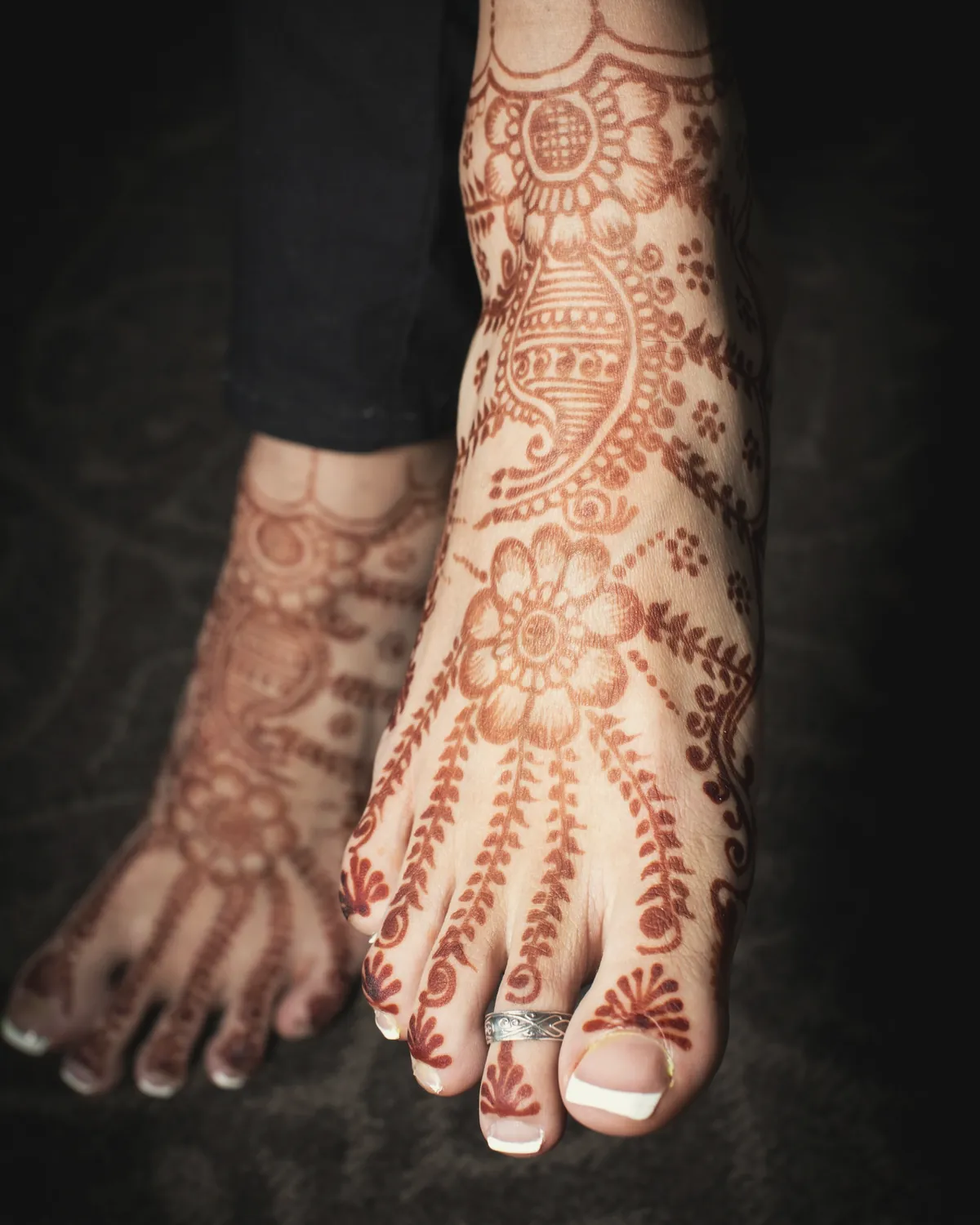 Bride showing intricate henna on both palms, with bangles