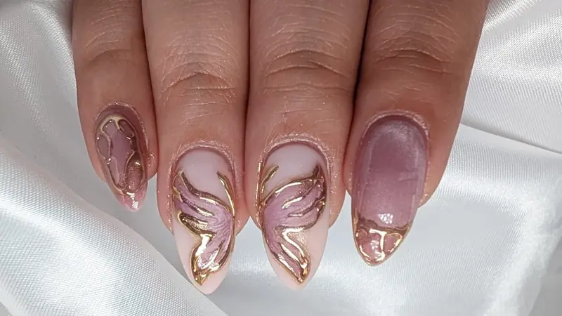 Almond nail extensions with pink butterfly art outlined in gold