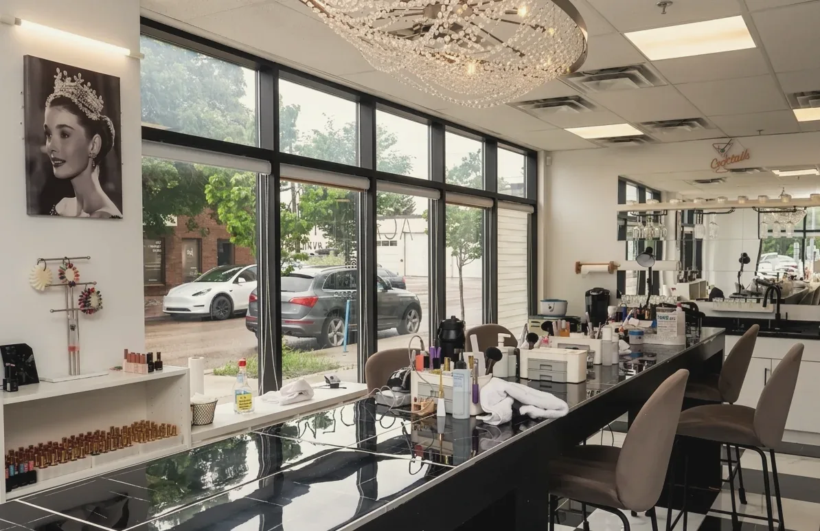 The manicure bar under a crystal chandelier, with windows onto 81 Avenue